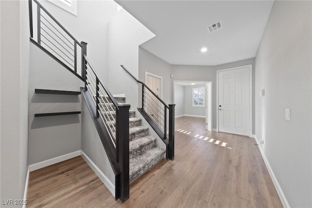 stairway featuring hardwood / wood-style flooring