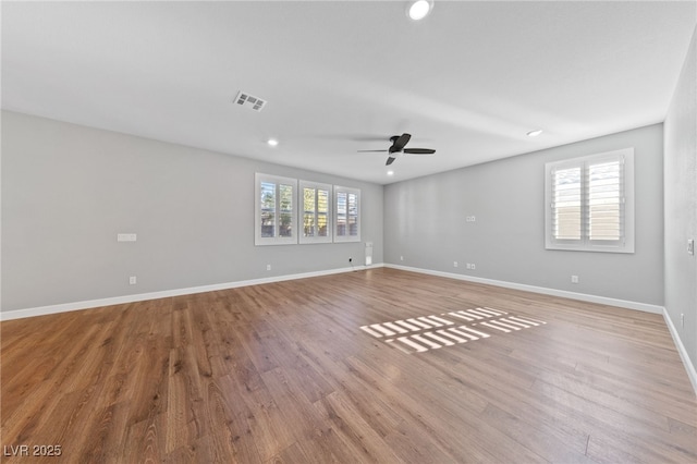 spare room featuring light wood-type flooring and ceiling fan