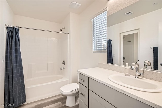 full bathroom with toilet, vanity, hardwood / wood-style flooring, and shower / bath combo with shower curtain