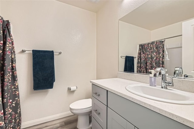 bathroom featuring toilet, a shower with shower curtain, vanity, and hardwood / wood-style flooring