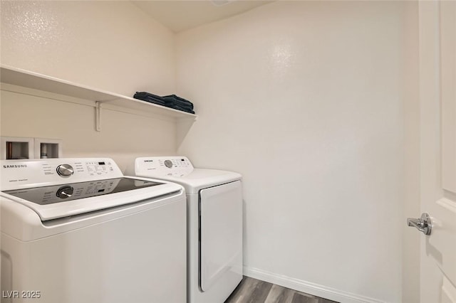 laundry room with independent washer and dryer and dark hardwood / wood-style floors