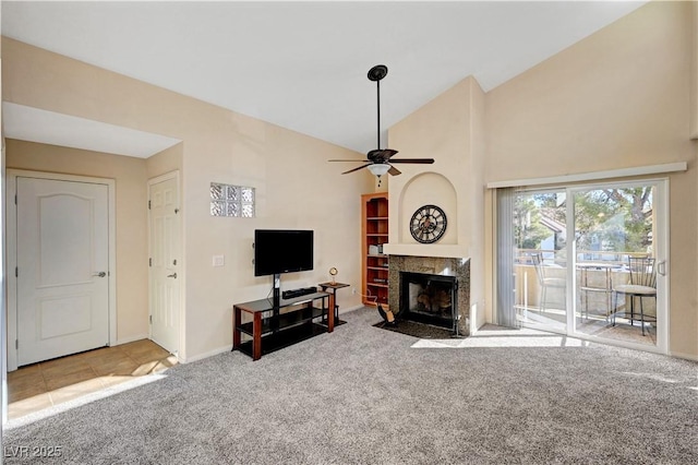 carpeted living room featuring lofted ceiling, a fireplace, and ceiling fan