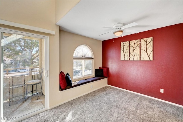 carpeted spare room featuring ceiling fan