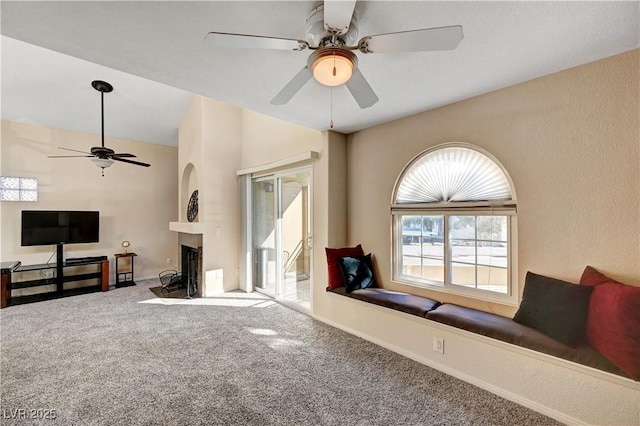 carpeted living room with ceiling fan