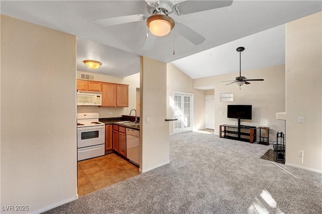 kitchen featuring white appliances, lofted ceiling, light colored carpet, ceiling fan, and sink