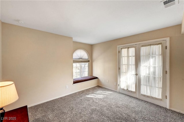 carpeted empty room featuring french doors