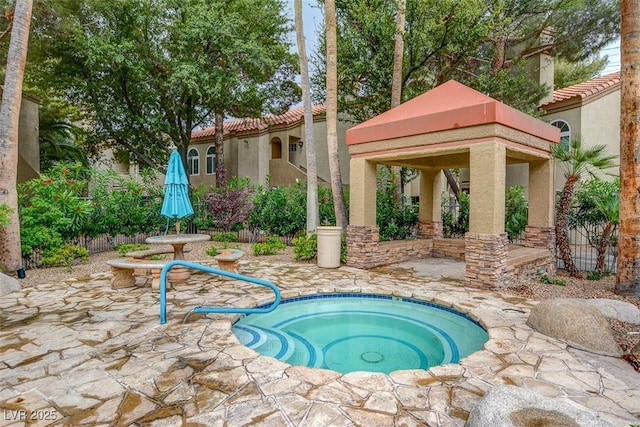 view of pool featuring a gazebo, a patio area, and an in ground hot tub