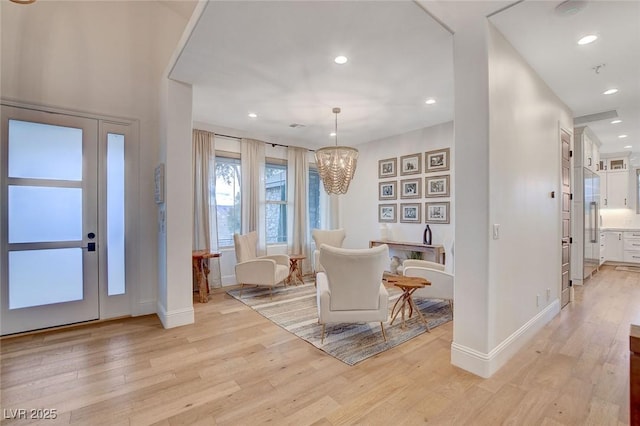 foyer entrance featuring a chandelier and light wood-type flooring