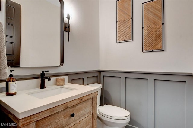 bathroom with toilet and vanity