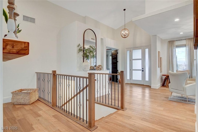 entrance foyer featuring an inviting chandelier and light hardwood / wood-style flooring