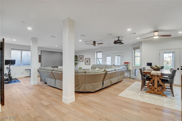 living room with ceiling fan, french doors, and light hardwood / wood-style floors