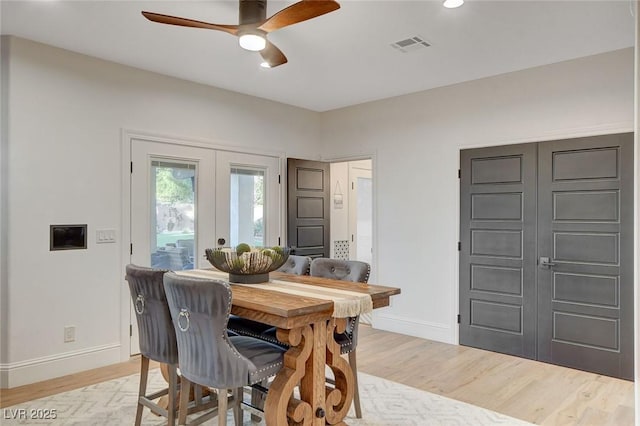 dining area with ceiling fan, french doors, and light hardwood / wood-style flooring