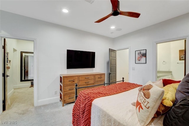 bedroom featuring light carpet, connected bathroom, and ceiling fan