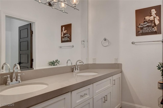 bathroom featuring a notable chandelier and vanity