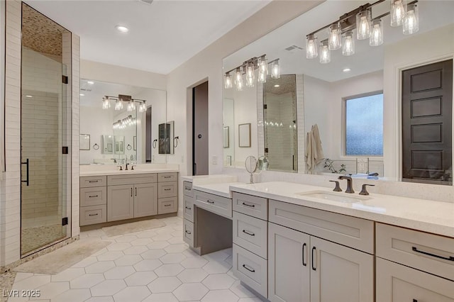 bathroom featuring vanity, tile patterned flooring, and a shower with shower door