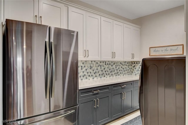 kitchen featuring stainless steel fridge, light tile patterned floors, tasteful backsplash, gray cabinetry, and white cabinets