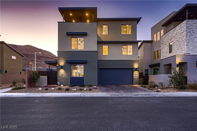 6289 Redstone Hills Dr, Las Vegas, NV 89148 - contemporary home with stucco siding, driveway, a garage, and fence