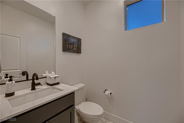 bathroom featuring toilet and vanity