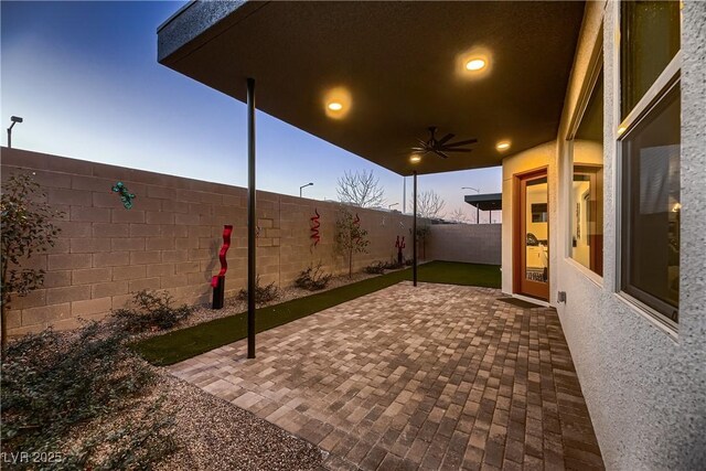 view of patio terrace at dusk