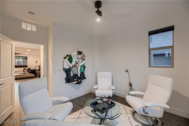 sitting room with ceiling fan and hardwood / wood-style flooring