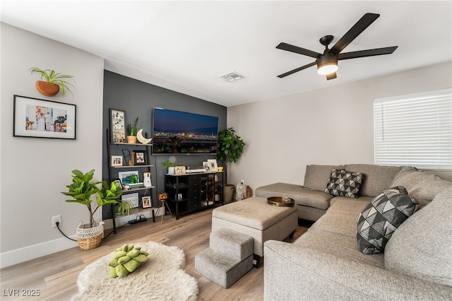 living room featuring ceiling fan and light hardwood / wood-style flooring