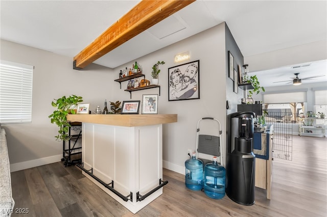 bar with ceiling fan, hardwood / wood-style flooring, white cabinets, and beamed ceiling