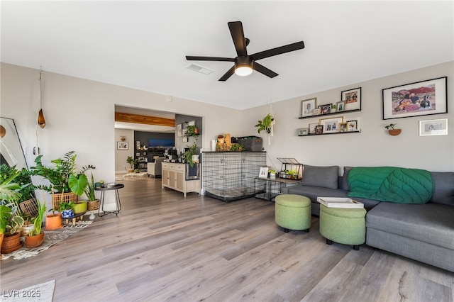 living room featuring ceiling fan and wood-type flooring