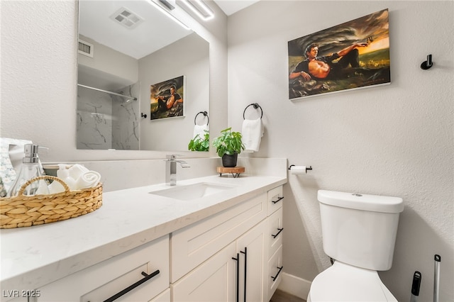 bathroom with a shower, toilet, and vanity