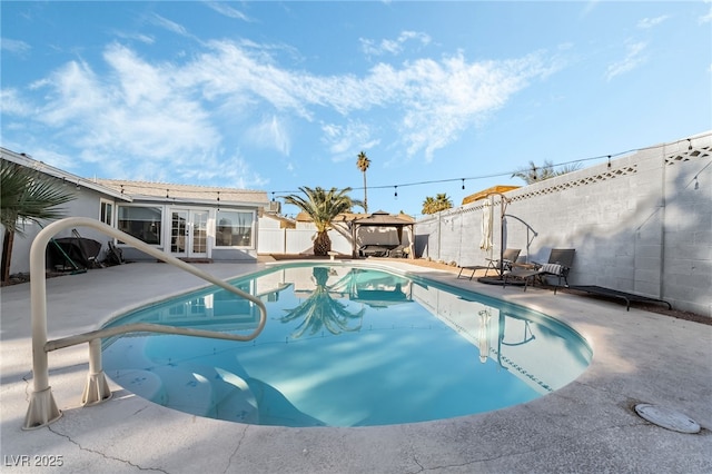 view of swimming pool with a gazebo, french doors, and a patio