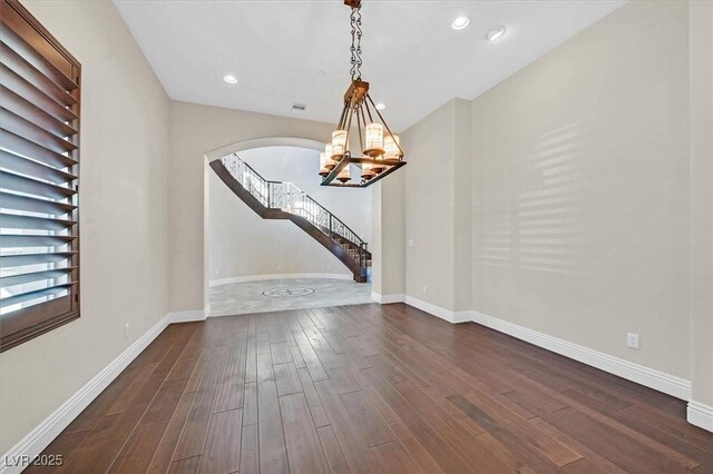 interior space featuring dark hardwood / wood-style flooring and an inviting chandelier