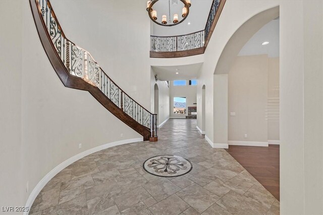 entryway featuring a high ceiling and a notable chandelier