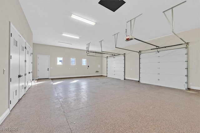 garage featuring baseboards and a garage door opener