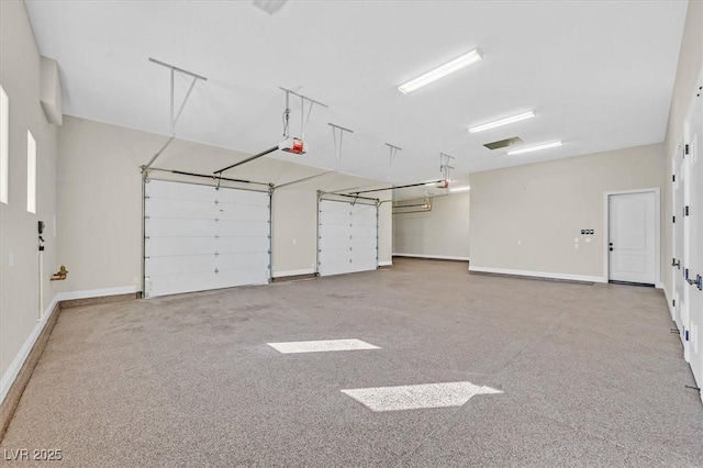 garage with baseboards and a garage door opener