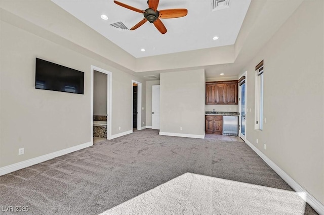 unfurnished living room with ceiling fan and light colored carpet