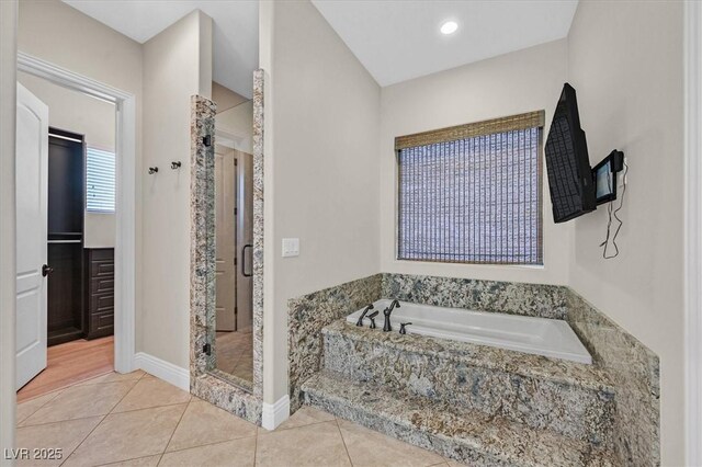 bathroom with tile patterned flooring and independent shower and bath