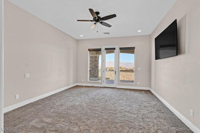 spare room featuring ceiling fan and carpet floors