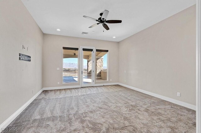 carpeted spare room with ceiling fan