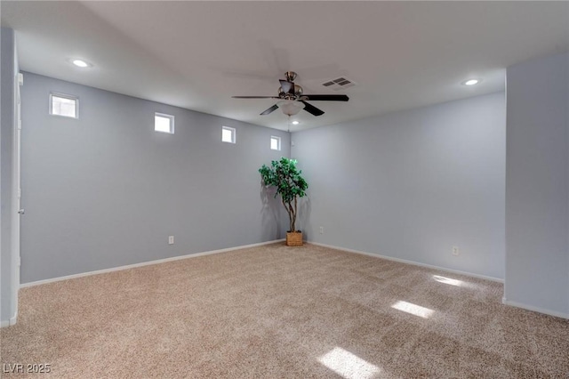 carpeted empty room featuring ceiling fan