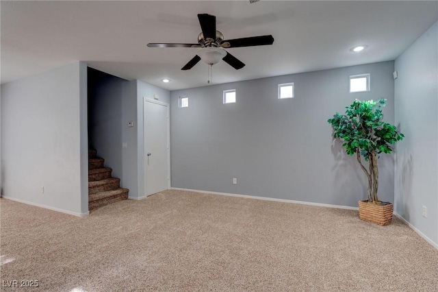 basement with ceiling fan and carpet flooring