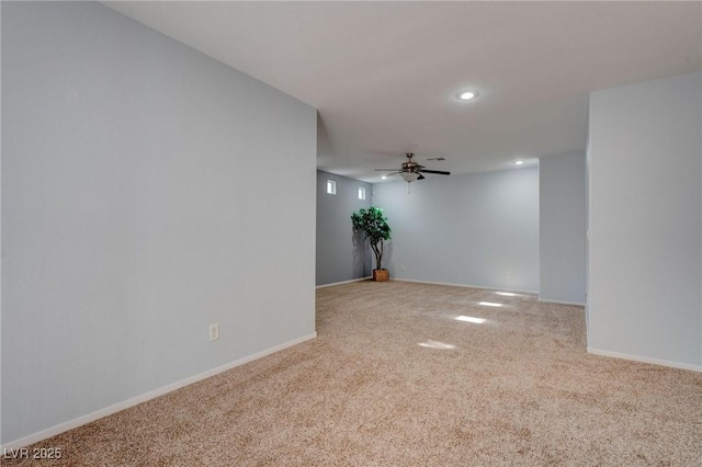 empty room with ceiling fan and light carpet