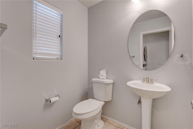 bathroom featuring toilet and tile patterned floors