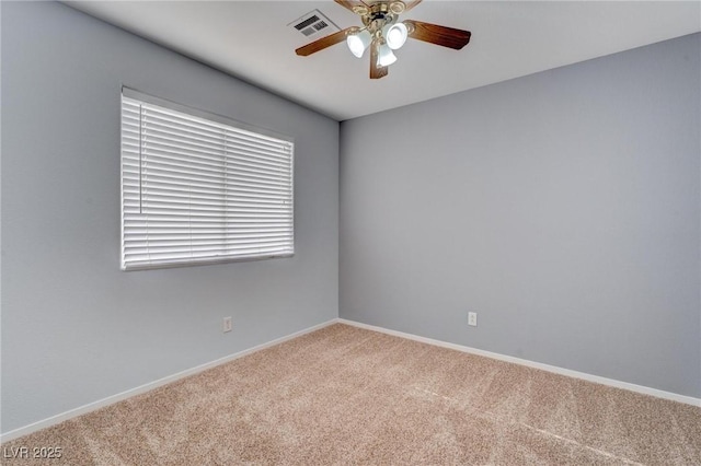 carpeted spare room with ceiling fan