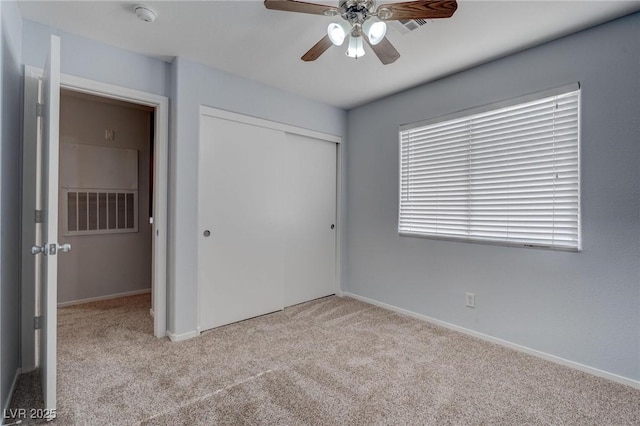 unfurnished bedroom with a closet, ceiling fan, and light colored carpet