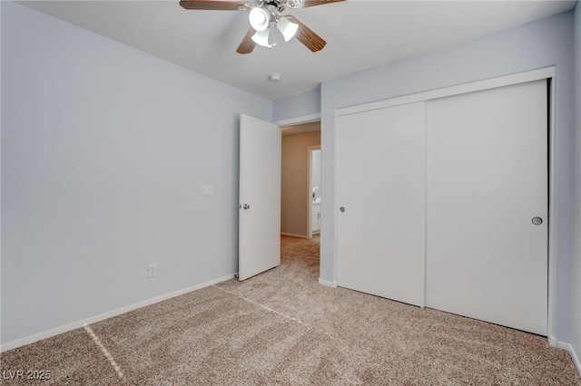 unfurnished bedroom with ceiling fan, a closet, and light carpet