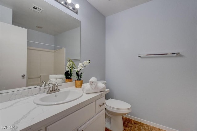 bathroom with toilet, walk in shower, and vanity