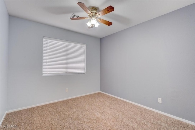 carpeted spare room featuring ceiling fan