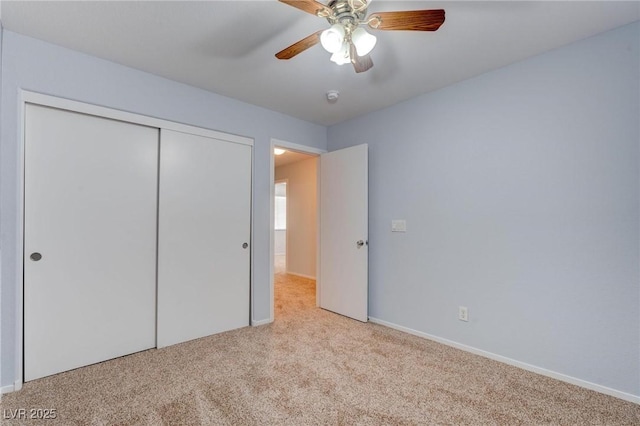 unfurnished bedroom with a closet, ceiling fan, and light colored carpet