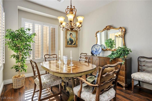 dining area featuring dark hardwood / wood-style floors, a chandelier, and a healthy amount of sunlight