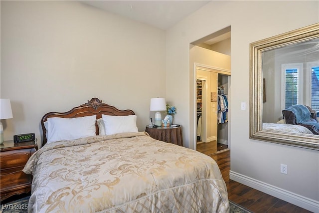 bedroom with a closet and dark hardwood / wood-style flooring