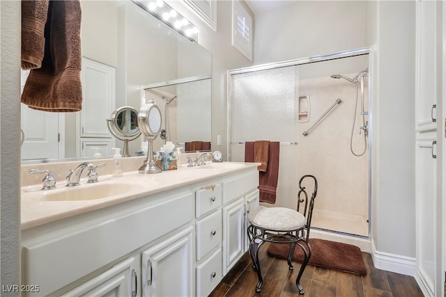 bathroom with a shower with shower door and vanity